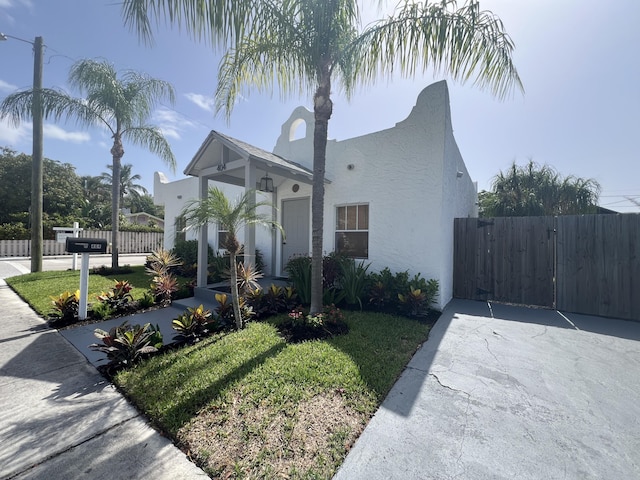 404 S M St Unit 1, Lake Worth Beach, FL 33460 - mediterranean / spanish-style house with stucco siding and a gate