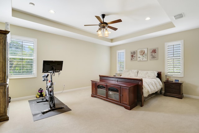 5621 SW Longspur Ln, Palm City, FL 34990 - bedroom featuring light colored carpet, baseboards, a tray ceiling, recessed lighting, and ceiling fan