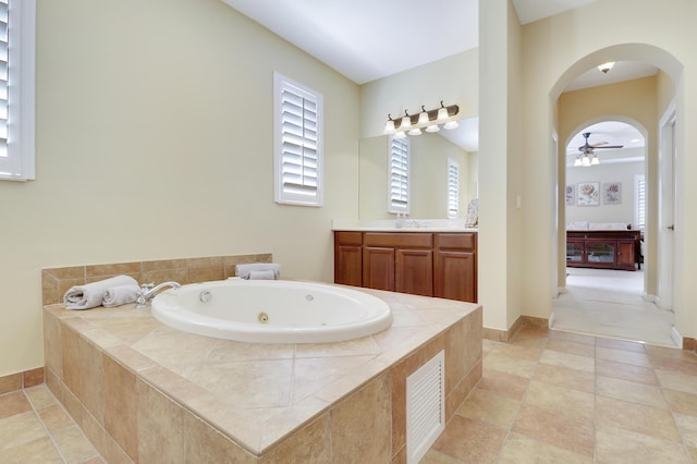 5621 SW Longspur Ln, Palm City, FL 34990 - bathroom featuring vanity, a tub with jets, and ceiling fan