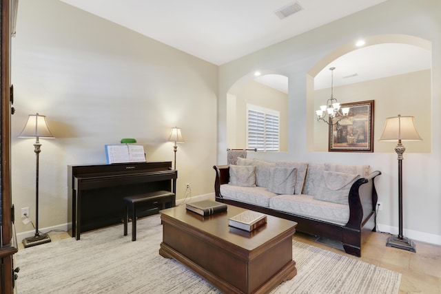 5621 SW Longspur Ln, Palm City, FL 34990 - living room with arched walkways, baseboards, and a chandelier