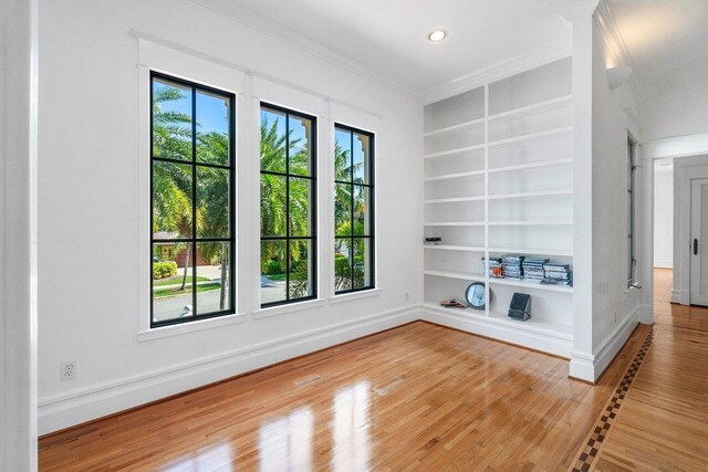 25 Harbor Dr, Lake Worth Beach, FL 33460 - spare room with built in shelves, ornamental molding, healthy amount of natural light, wood finished floors, and recessed lighting
