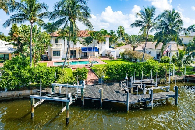 25 Harbor Dr, Lake Worth Beach, FL 33460 - dock featuring boat lift, an outdoor pool, a water view, and a patio