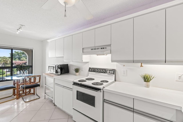 5380 Cedar Lake Dr Unit 303, Boynton Beach, FL 33437 - kitchen with white electric range oven, under cabinet range hood, light countertops, a textured ceiling, and white cabinetry