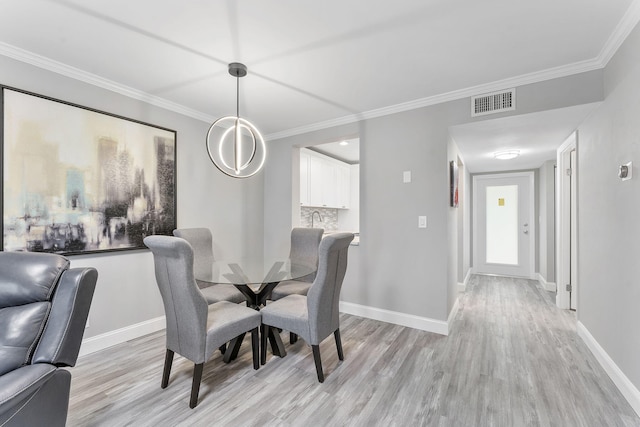 118 Lake Constance Dr Unit 118, West Palm Beach, FL 33411 - dining area with light wood-style floors and crown molding