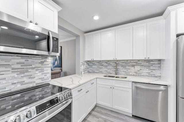 118 Lake Constance Dr Unit 118, West Palm Beach, FL 33411 - kitchen featuring appliances with stainless steel finishes, tasteful backsplash, white cabinetry, light stone countertops, and recessed lighting