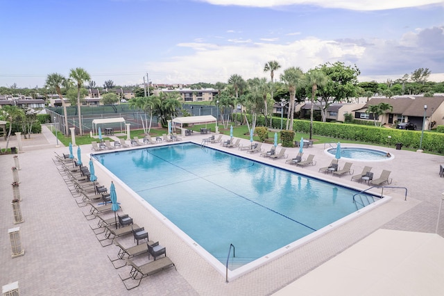 118 Lake Constance Dr Unit 118, West Palm Beach, FL 33411 - community pool featuring a hot tub, a patio area, and a residential view