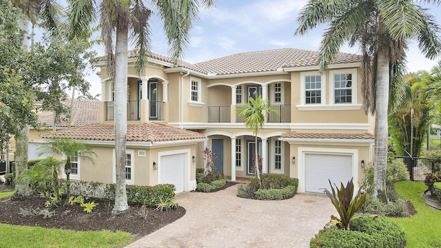 5605 SW Gray Fox Dr, Palm City, FL 34990 - view of front facade with a balcony, decorative driveway, a garage, and stucco siding