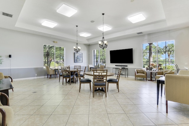 5605 SW Gray Fox Dr, Palm City, FL 34990 - dining space with a raised ceiling, a chandelier, baseboards, and light tile patterned floors