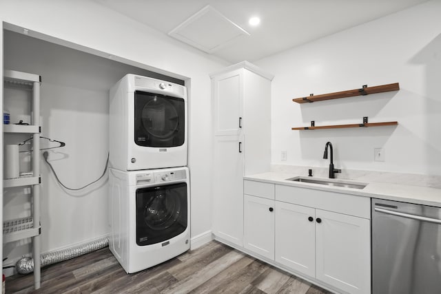 3571 SE Cobia Way, Stuart, FL 34997 - laundry room featuring stacked washing machine and dryer, dark wood-style floors, and attic access