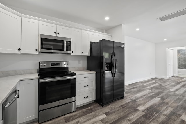 3571 SE Cobia Way, Stuart, FL 34997 - kitchen featuring stainless steel appliances, dark wood-style flooring, white cabinetry, light stone counters, and recessed lighting