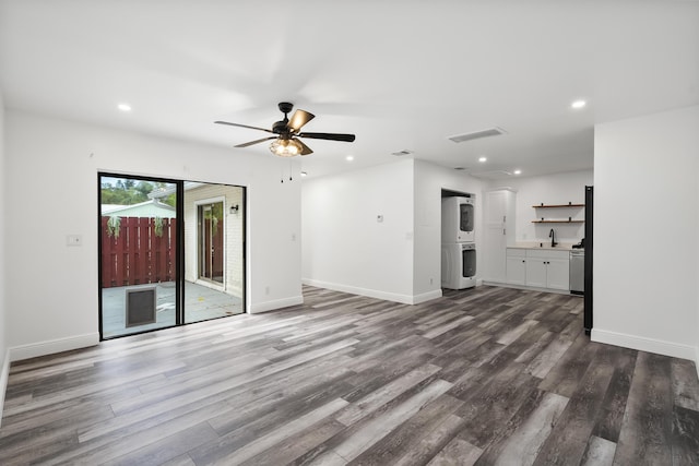 3571 SE Cobia Way, Stuart, FL 34997 - unfurnished living room featuring estacked washer and dryer, wood finished floors, recessed lighting, a sink, and baseboards