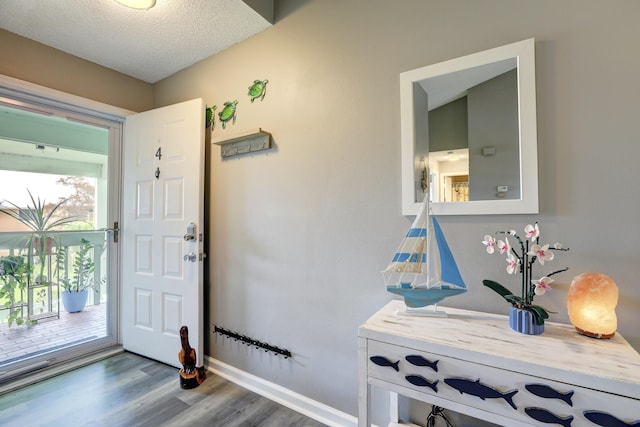 5725 Pelican Pointe Dr Unit 4, Sebastian, FL 32958 - entryway featuring wood finished floors, a textured ceiling, and baseboards