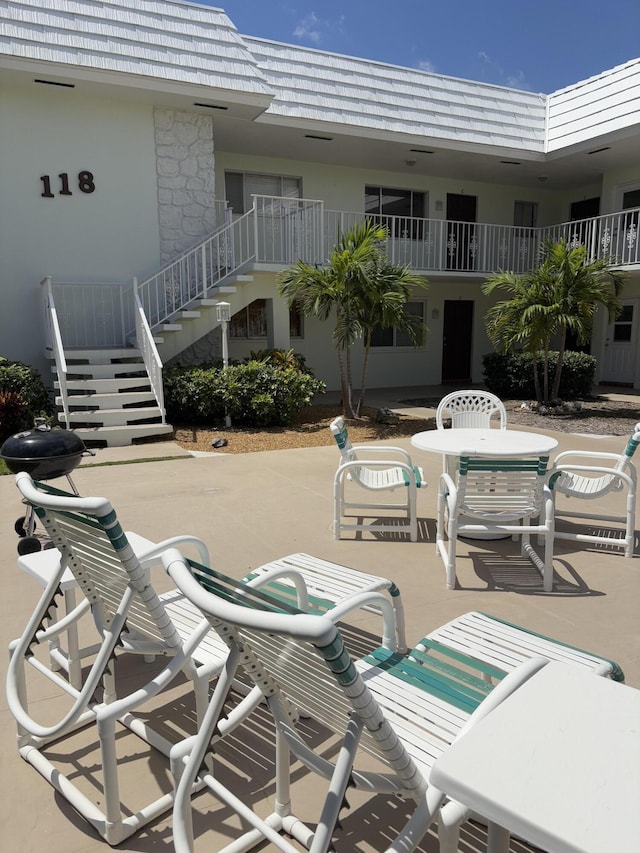 118 Yacht Club Dr Unit 1, North Palm Beach, FL 33408 - view of patio / terrace with stairway and outdoor dining space