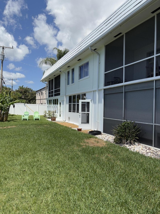 118 Yacht Club Dr Unit 1, North Palm Beach, FL 33408 - back of house with a sunroom