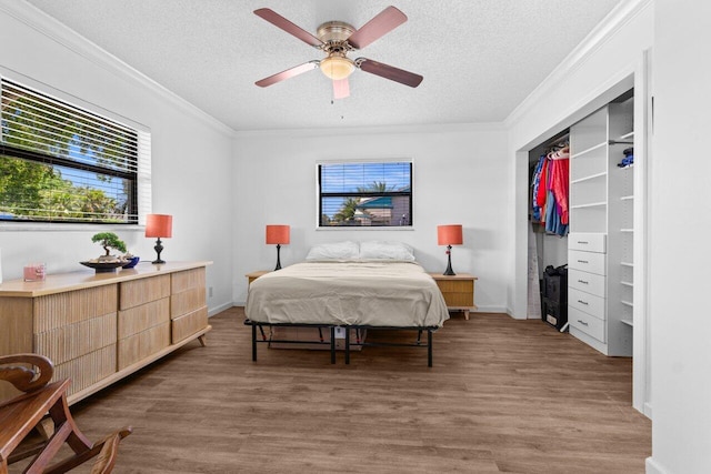 4694 Brady Blvd, Delray Beach, FL 33445 - bedroom featuring ornamental molding, a textured ceiling, wood finished floors, and ceiling fan