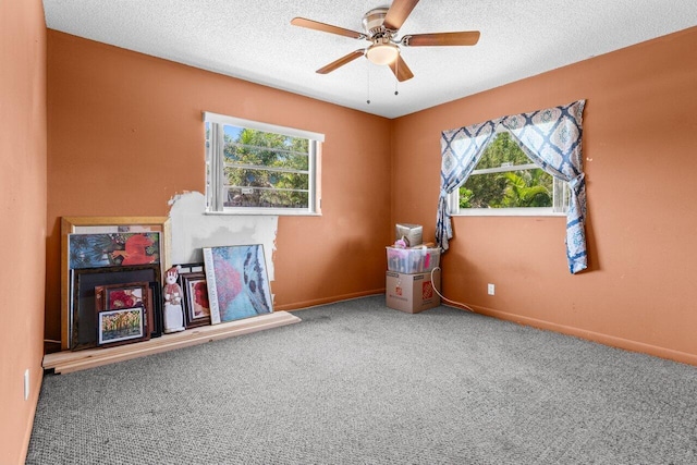 4694 Brady Blvd, Delray Beach, FL 33445 - unfurnished bedroom featuring multiple windows, carpet flooring, a textured ceiling, and ceiling fan