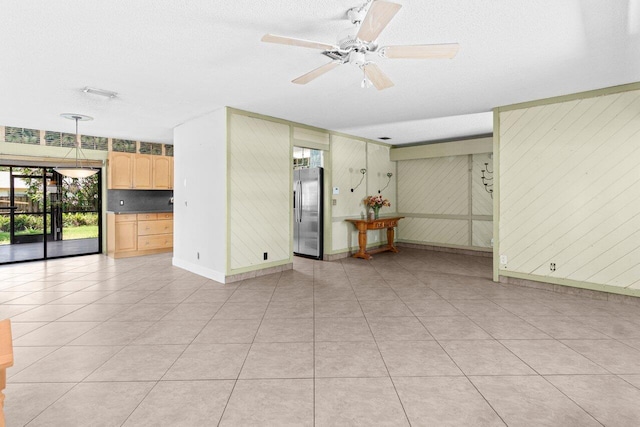 4694 Brady Blvd, Delray Beach, FL 33445 - spare room with wooden walls, a textured ceiling, a ceiling fan, and light tile patterned flooring