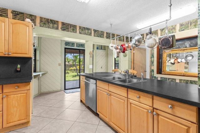 4694 Brady Blvd, Delray Beach, FL 33445 - kitchen with stainless steel dishwasher, a textured ceiling, dark countertops, and light tile patterned floors