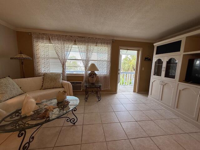 368 Sheffield O, West Palm Beach, FL 33417 - living area with ornamental molding, a textured ceiling, and light tile patterned floors