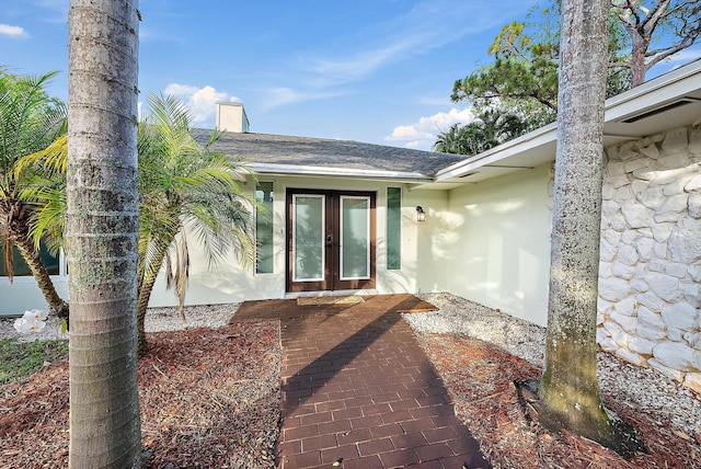19960 Earlwood Dr, Jupiter, FL 33458 - doorway to property featuring french doors, stucco siding, and roof with shingles