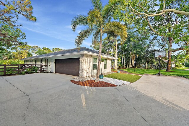 19960 Earlwood Dr, Jupiter, FL 33458 - view of home's exterior with an attached garage and asphalt driveway