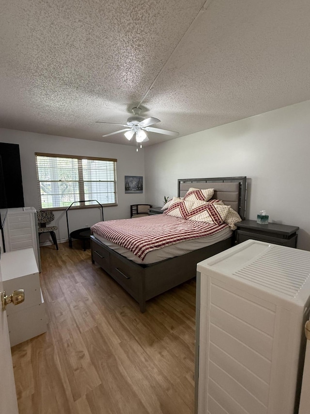 1041 Guildford C, Boca Raton, FL 33434 - bedroom featuring light wood finished floors, a textured ceiling, and a ceiling fan