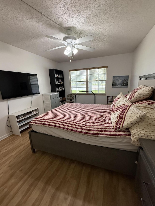 1041 Guildford C, Boca Raton, FL 33434 - bedroom with wood finished floors, a textured ceiling, and a ceiling fan