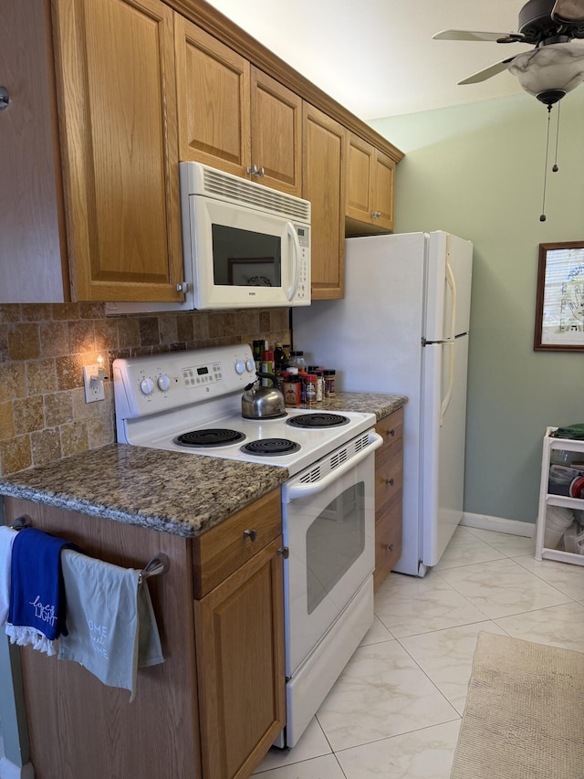 1041 Guildford C, Boca Raton, FL 33434 - kitchen featuring white appliances, light marble finish flooring, tasteful backsplash, and brown cabinetry