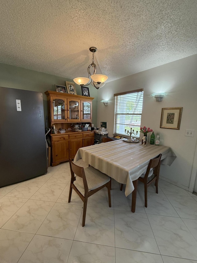 1041 Guildford C, Boca Raton, FL 33434 - dining area featuring light marble finish flooring and a textured ceiling