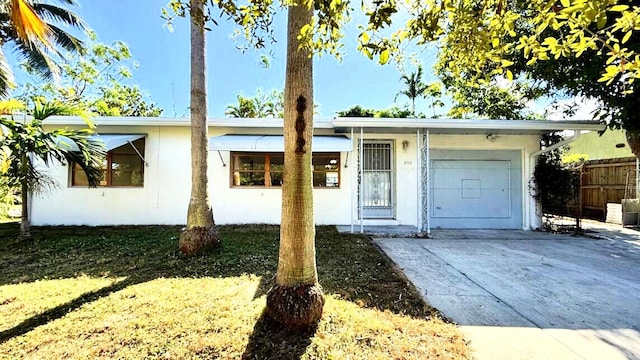 802 Lytle St, West Palm Beach, FL 33405 - ranch-style house with a garage, driveway, and stucco siding