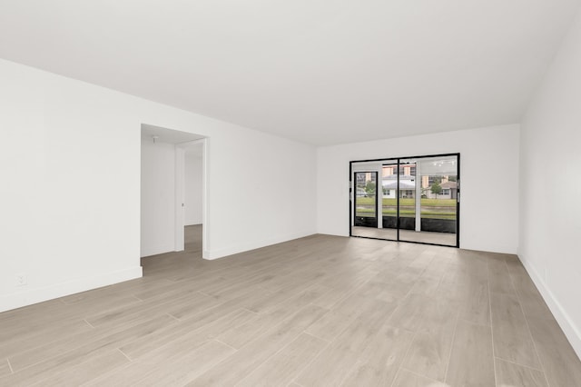 7290 Kinghurst Dr Unit 102, Delray Beach, FL 33446 - empty room featuring light wood-style floors and baseboards