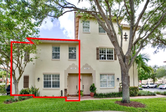 1020 E Longport Cir Unit A1, Delray Beach, FL 33444 - view of property featuring stucco siding and a front yard