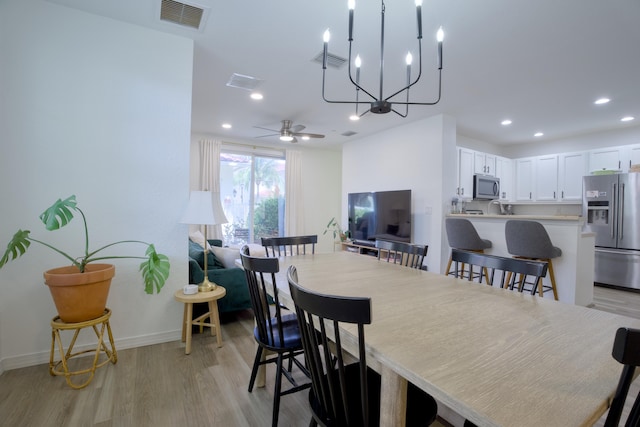 1020 E Longport Cir Unit A1, Delray Beach, FL 33444 - dining area featuring light wood finished floors, recessed lighting, baseboards, ceiling fan, and a chandelier
