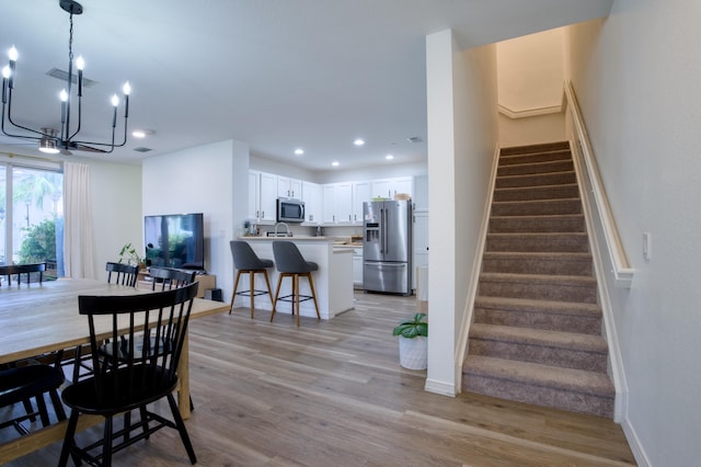 1020 E Longport Cir Unit A1, Delray Beach, FL 33444 - dining space featuring a chandelier, stairway, light wood-type flooring, recessed lighting, and baseboards