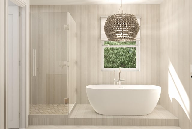227 Greymon Dr, West Palm Beach, FL 33405 - bathroom with a freestanding bath, a walk in shower, wallpapered walls, and a chandelier