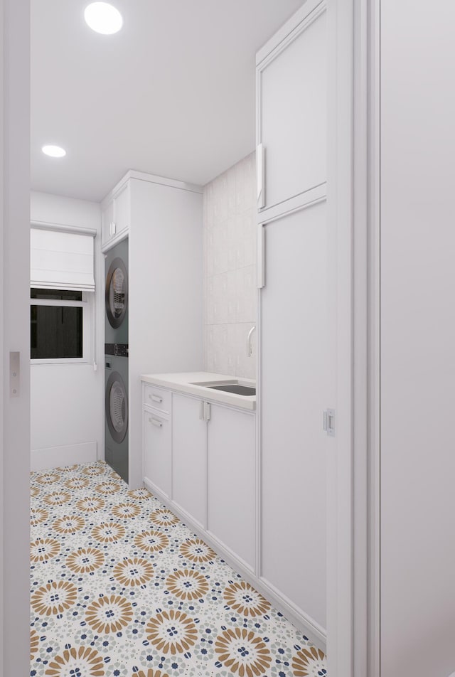 227 Greymon Dr, West Palm Beach, FL 33405 - washroom featuring stacked washing machine and dryer, cabinet space, tile patterned floors, and recessed lighting