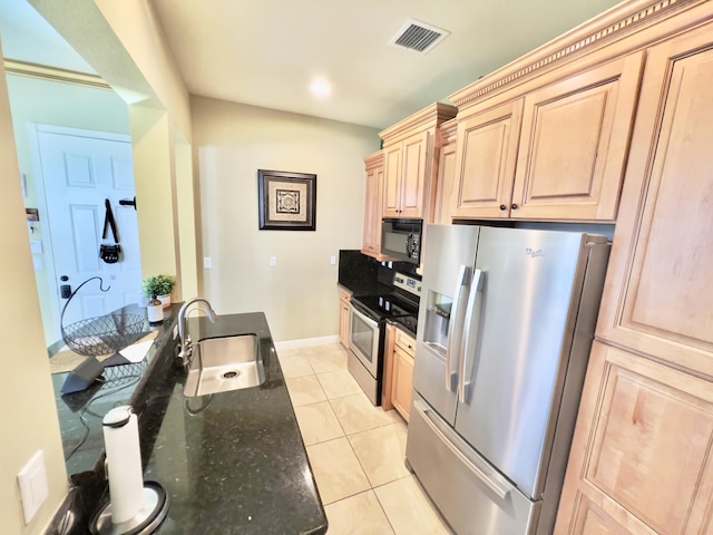 8300 NW 9th Ave, Boca Raton, FL 33487 - kitchen with stainless steel appliances, a sink, light brown cabinets, light tile patterned flooring, and dark stone counters