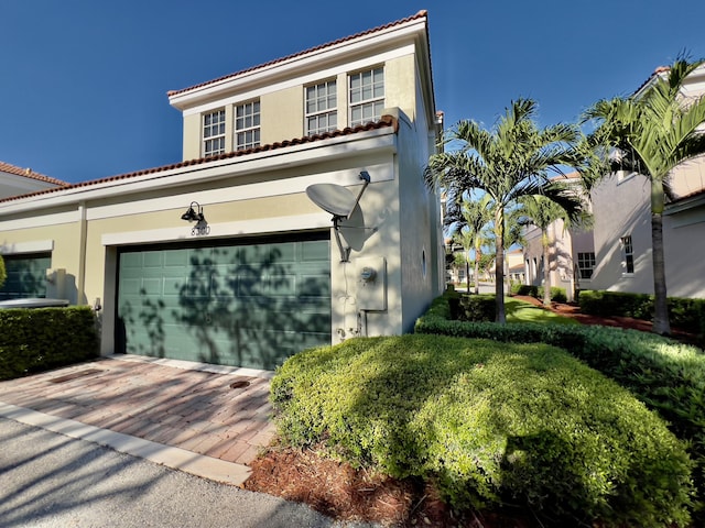 8300 NW 9th Ave, Boca Raton, FL 33487 - mediterranean / spanish-style home featuring stucco siding, a tile roof, and decorative driveway