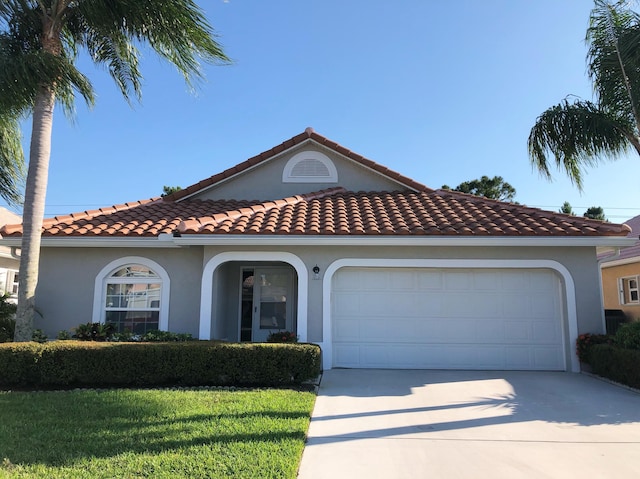 4393 SE Scotland Cay Way, Stuart, FL 34997 - mediterranean / spanish house with driveway, an attached garage, and stucco siding