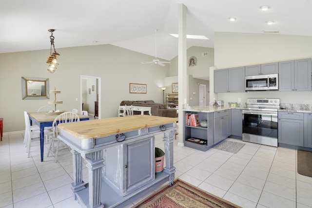 4393 SE Scotland Cay Way, Stuart, FL 34997 - kitchen featuring appliances with stainless steel finishes, gray cabinetry, open shelves, light tile patterned flooring, and a ceiling fan
