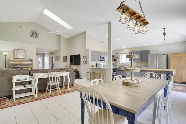 4393 SE Scotland Cay Way, Stuart, FL 34997 - dining area featuring high vaulted ceiling, a skylight, light tile patterned floors, and a ceiling fan