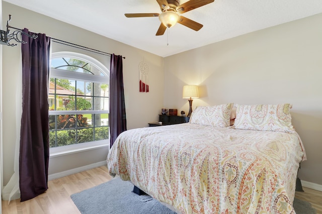 4393 SE Scotland Cay Way, Stuart, FL 34997 - bedroom with multiple windows, wood finished floors, and ceiling fan