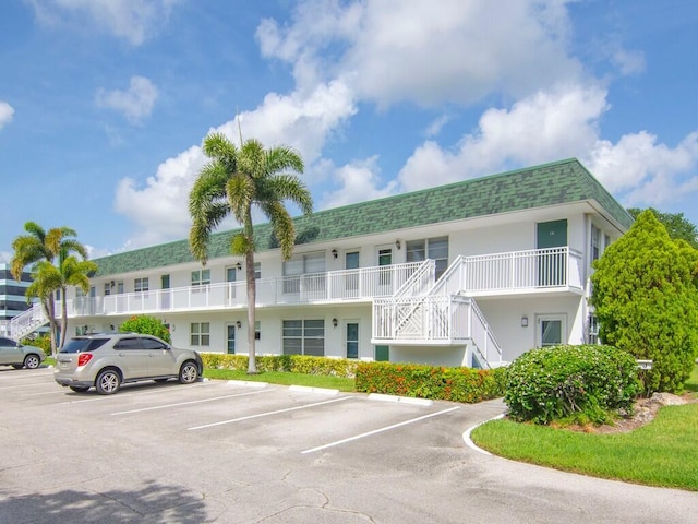 2800 Indian River Blvd Unit J6, Vero Beach, FL 32960 - view of property featuring uncovered parking and stairs