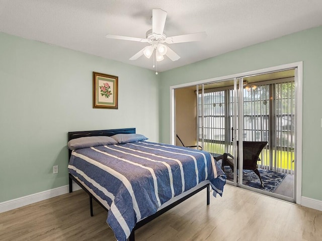 2800 Indian River Blvd Unit J6, Vero Beach, FL 32960 - bedroom with wood finished floors, access to exterior, and a ceiling fan