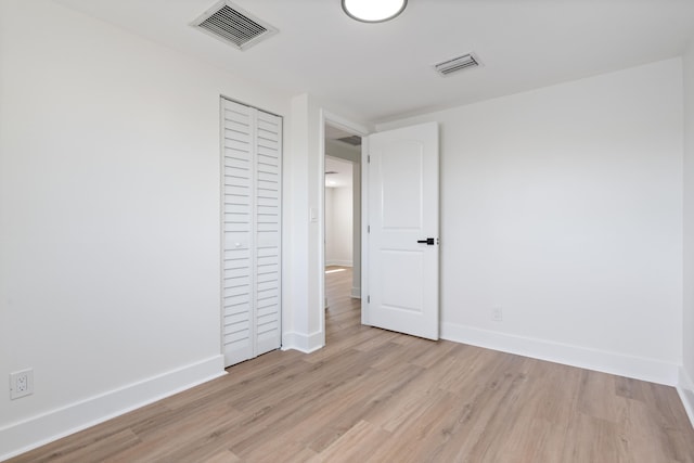 88 3rd St, West Palm Beach, FL 33413 - unfurnished bedroom with light wood-type flooring, baseboards, and a closet