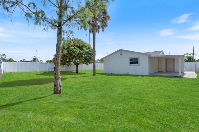 88 3rd St, West Palm Beach, FL 33413 - view of yard featuring a patio area and a carport