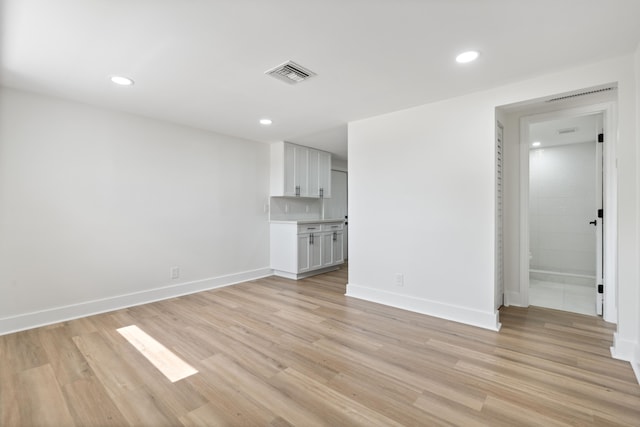 88 3rd St, West Palm Beach, FL 33413 - unfurnished living room featuring light wood finished floors, baseboards, and recessed lighting
