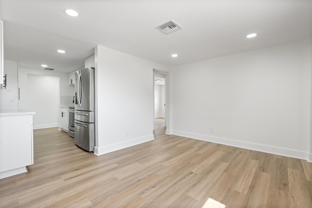 88 3rd St, West Palm Beach, FL 33413 - unfurnished living room with light wood-type flooring, recessed lighting, and baseboards