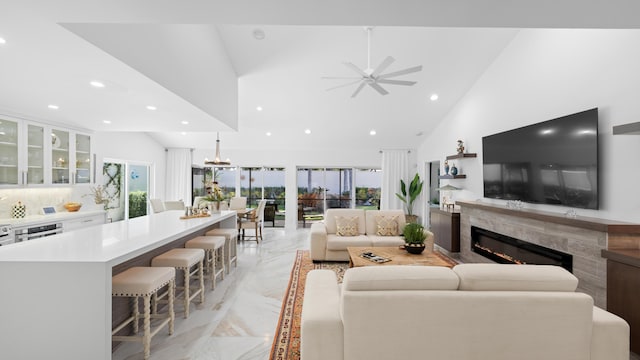 21415 Campo Allegro Dr, Boca Raton, FL 33433 - living room with light marble finish floors, a high end fireplace, a ceiling fan, recessed lighting, and high vaulted ceiling