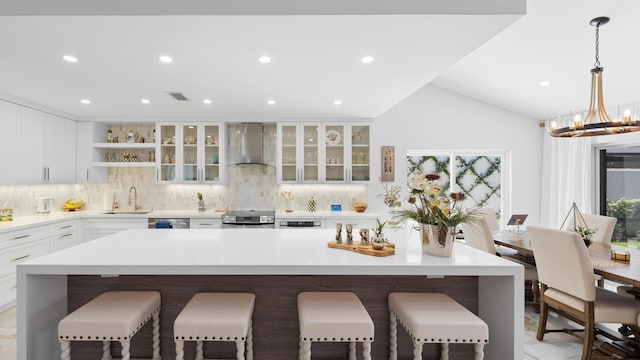 21415 Campo Allegro Dr, Boca Raton, FL 33433 - kitchen with wall chimney range hood, a breakfast bar, a sink, decorative backsplash, and open shelves